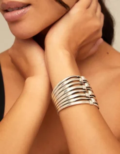 Bangle bracelet with multiple nail heads