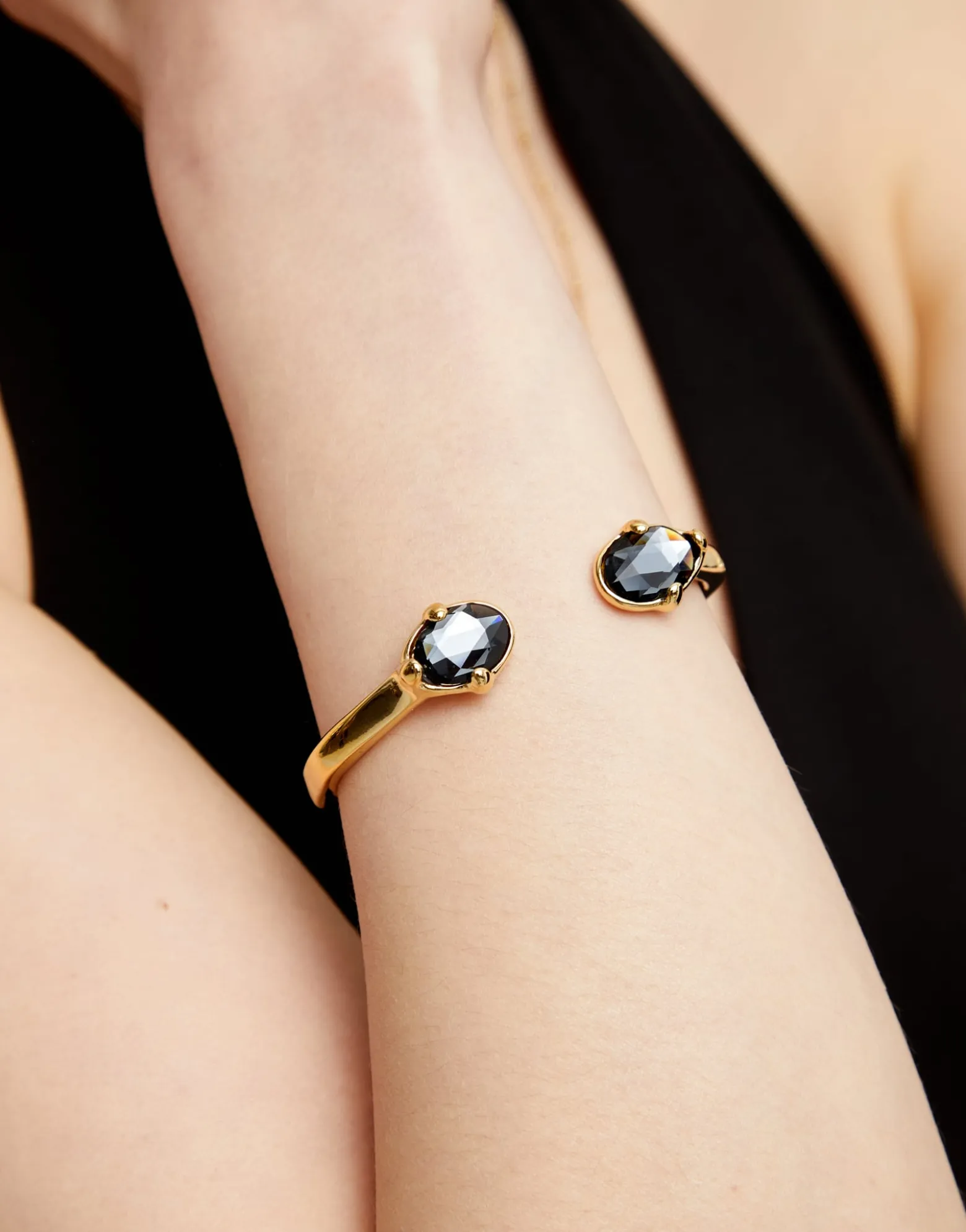 Bangle bracelet with two faceted black oval crystals