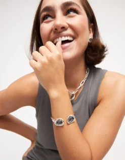 Bangle bracelet with two grey crystals