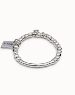 Beaded stretch bracelet with tubular piece and a charm