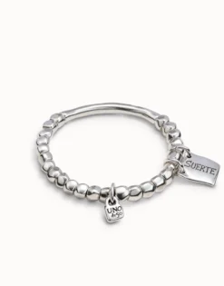 Beaded stretch bracelet with tubular piece and a charm