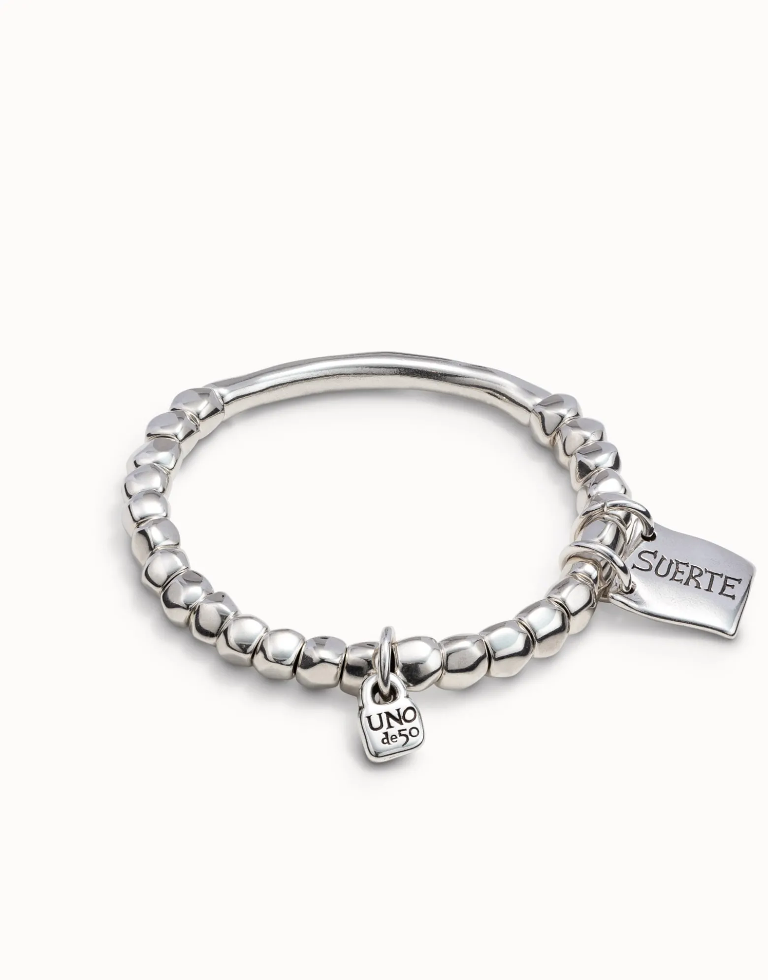 Beaded stretch bracelet with tubular piece and a charm