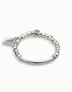 Beaded stretch bracelet with tubular piece and charms