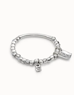 Beaded stretch bracelet with tubular piece and charms