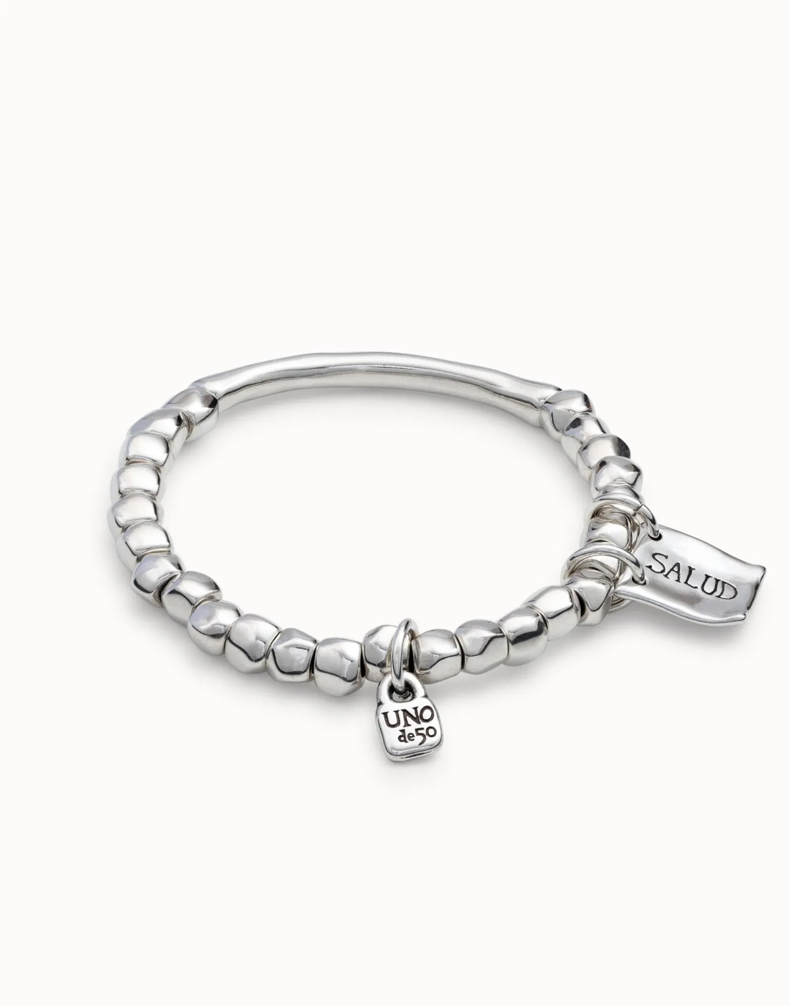 Beaded stretch bracelet with tubular piece and charms