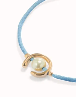 Blue cord bracelet with a pearl