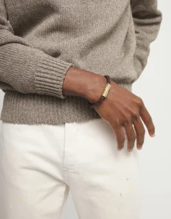 Brown braided leather bracelet with a metal detail