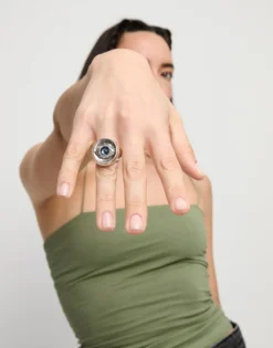 Eye-shaped ring with faceted blue crystal