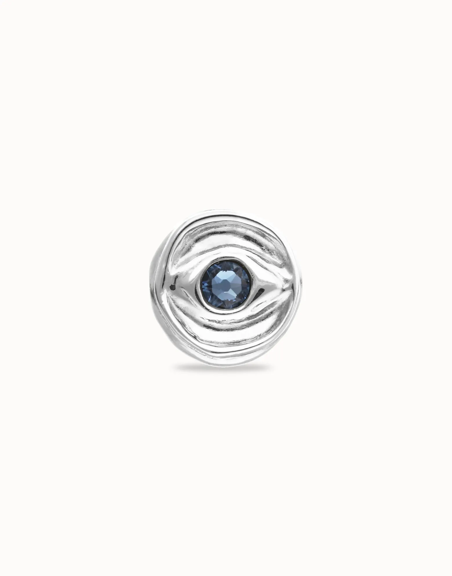 Eye-shaped ring with faceted blue crystal
