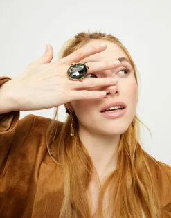Large ring with oval faceted gray crystal