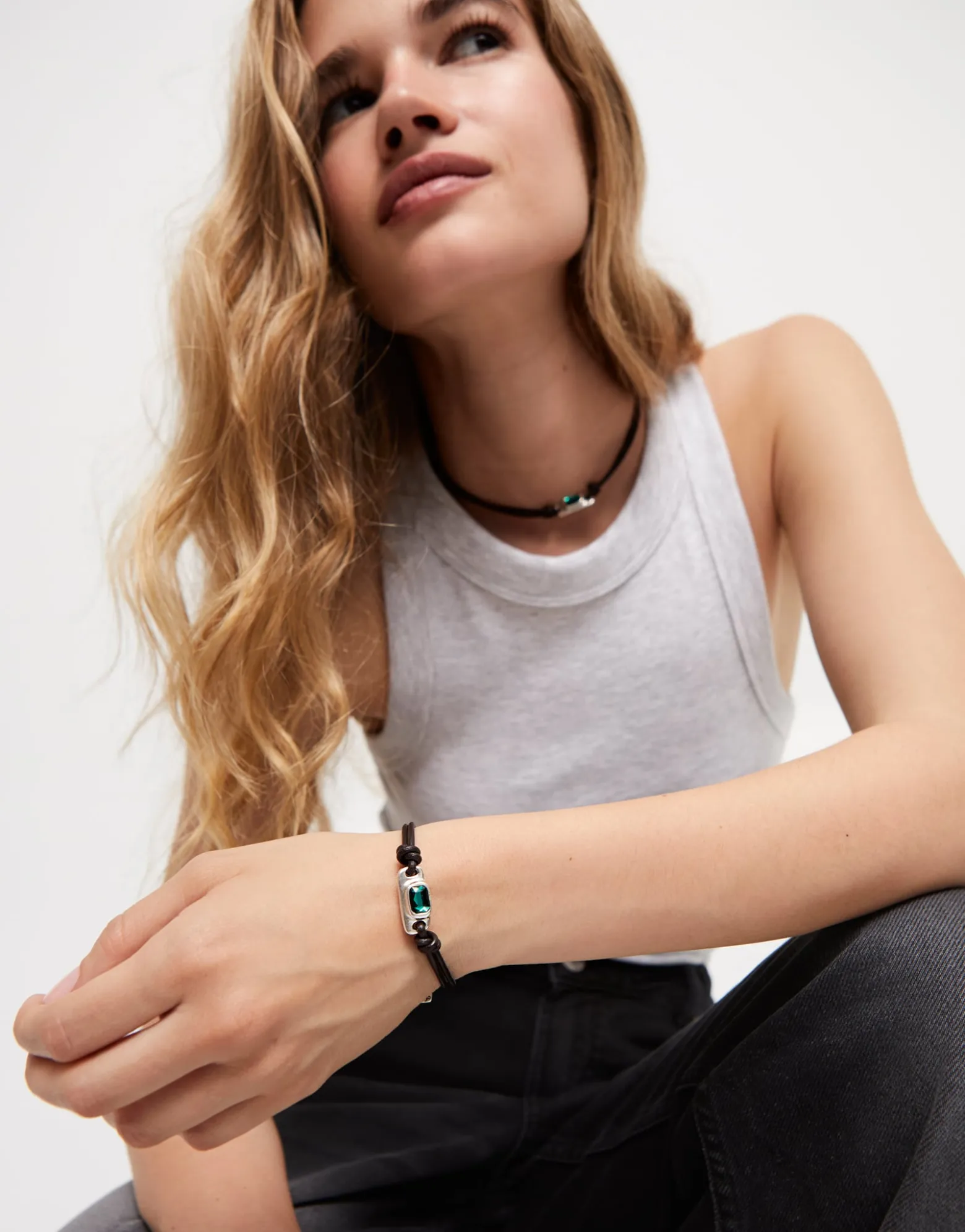 Leather bracelet with a green crystal