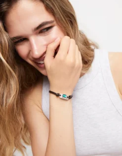 Leather bracelet with a green crystal
