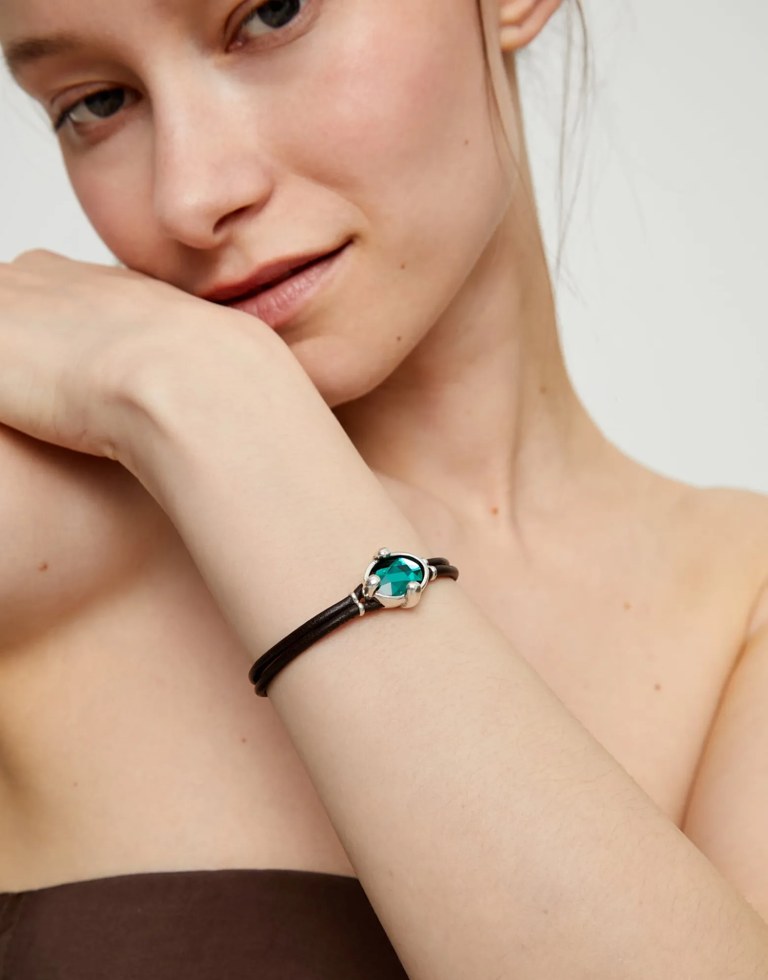 Leather bracelet with green oval faceted crystal