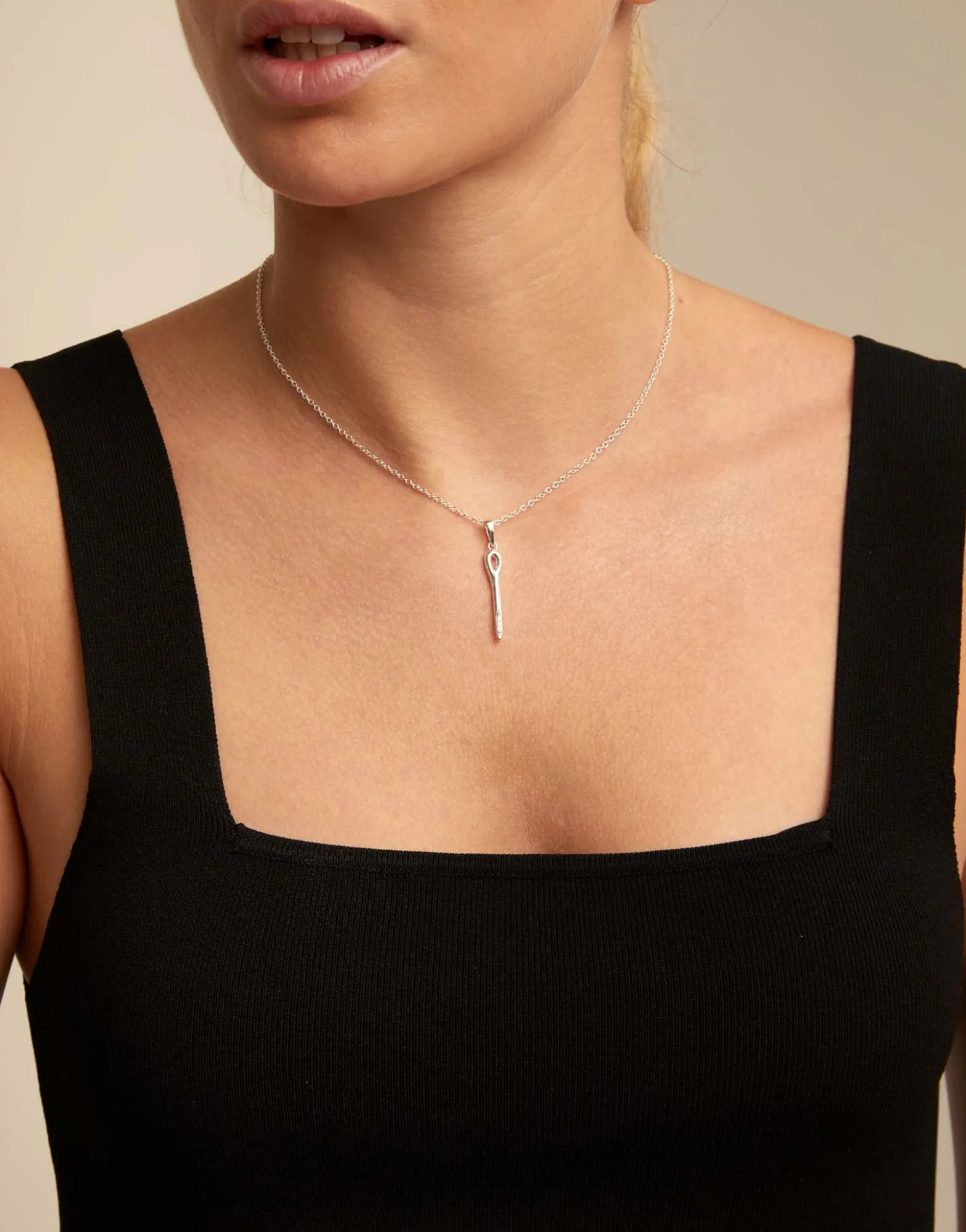 Long chain pendant necklace with needle