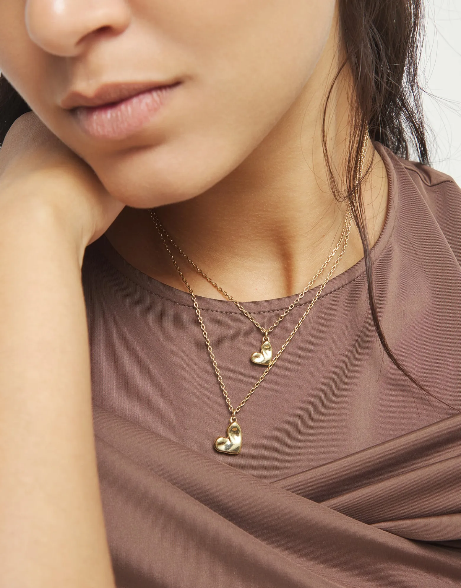 Multi strand chain necklace with two hearts
