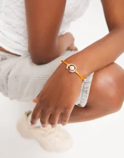 Orange cord bracelet with a pearl