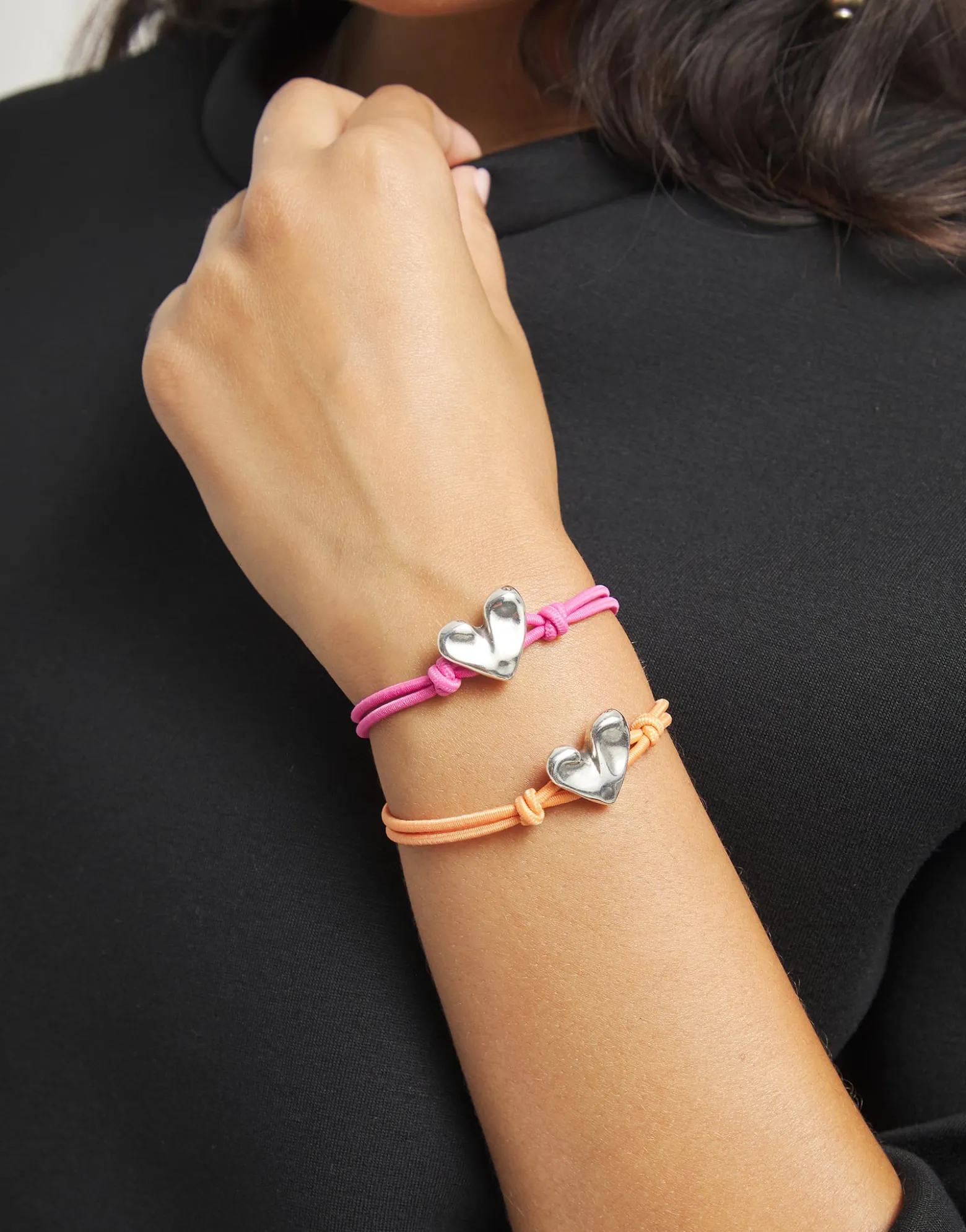 Orange elastic thread bracelet with heart