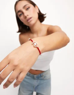 Red cord bracelet with a pearl